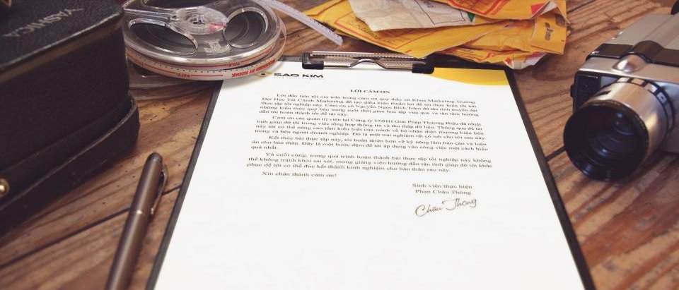 A signed document and correspondence on a desk